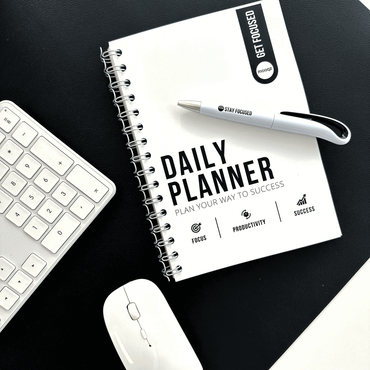 Daily planner on a desk with a pen, keyboard, and mouse, designed for productivity and success.