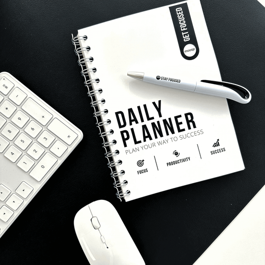 Daily planner on a desk with a pen, keyboard, and mouse, designed for productivity and success.